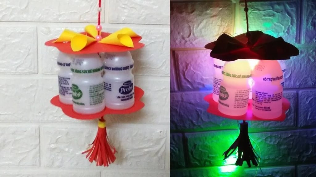 Lồng đèn Trung Thu làm từ chai sữa chua, thủ công sáng tạo, ánh sáng LED rực rỡ trên tường gạch.